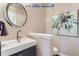 Elegant powder room with modern vanity and art at 4508 E Louisiana Ave, Denver, CO 80246