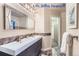 Modern bathroom with double vanity and access to closet at 4508 E Louisiana Ave, Denver, CO 80246