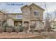 Two-story townhome with stone and siding exterior, landscaping, and walkway at 4508 E Louisiana Ave, Denver, CO 80246