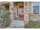 Inviting front entrance with stone accents and a red door at 4508 E Louisiana Ave, Denver, CO 80246