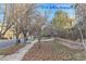 Landscaped front yard with mature trees and walkway at 4508 E Louisiana Ave, Denver, CO 80246
