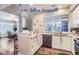 Modern kitchen with white cabinets, granite counters, and stainless steel appliances at 4508 E Louisiana Ave, Denver, CO 80246
