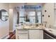 Modern kitchen with white cabinets, granite counters, and island at 4508 E Louisiana Ave, Denver, CO 80246