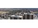 Drone view shows apartment buildings with community, park, lake, and neighborhood in the distance at 7865 E Mississippi Ave # 702, Denver, CO 80247