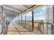 Enclosed balcony featuring sliding glass doors, city views, and bright sunlight at 7865 E Mississippi Ave # 702, Denver, CO 80247