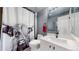 Bathroom featuring a toilet, sink, and shower with a stylish black-and-white shower curtain at 7865 E Mississippi Ave # 702, Denver, CO 80247