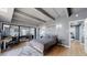 This bedroom features exposed beams and a large mirror closet at 7865 E Mississippi Ave # 702, Denver, CO 80247
