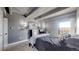Bedroom with a queen bed, exposed ceiling beams, TV, and a gaming setup by the window at 7865 E Mississippi Ave # 702, Denver, CO 80247