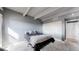 Bedroom featuring grey walls, carpet, exposed ceiling beams, and a queen bed at 7865 E Mississippi Ave # 702, Denver, CO 80247