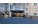 Welcoming entrance to the building with a covered walkway and accessibility ramp at 7865 E Mississippi Ave # 702, Denver, CO 80247