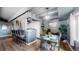 Elegant dining area with a modern table, bar seating, and seamless transition to the kitchen area at 7865 E Mississippi Ave # 702, Denver, CO 80247