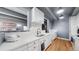 Modern kitchen with white cabinetry, granite countertops, and stainless steel appliances at 7865 E Mississippi Ave # 702, Denver, CO 80247