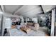 Spacious living area seamlessly flowing into the dining and kitchen spaces, with modern furnishings at 7865 E Mississippi Ave # 702, Denver, CO 80247
