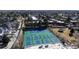 Aerial view of a well-maintained pickleball court area and gazebo, surrounded by lush landscaping and community buildings at 7865 E Mississippi Ave # 702, Denver, CO 80247