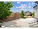Charming backyard patio with lattice fencing and a view of the home's exterior at 5021 S Rome St, Aurora, CO 80015