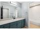 Bathroom featuring neutral countertops, vanity with ample storage, and shower tub combo at 5021 S Rome St, Aurora, CO 80015