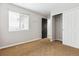 Bedroom featuring a closet with sliding doors and a window for natural light at 5021 S Rome St, Aurora, CO 80015