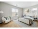Bedroom with natural light, stylish decor, and a cozy seating area at 5021 S Rome St, Aurora, CO 80015