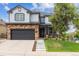 Inviting two-story home featuring an attached garage and neatly landscaped yard at 5021 S Rome St, Aurora, CO 80015