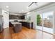 Well-equipped kitchen featuring dark wood cabinets, stainless steel appliances, and patio access at 5021 S Rome St, Aurora, CO 80015