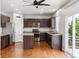 Modern kitchen with dark wood cabinets, stainless steel appliances, and wood flooring at 5021 S Rome St, Aurora, CO 80015