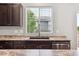 Well lit kitchen with dark cabinets and stainless steel dishwasher at 5021 S Rome St, Aurora, CO 80015