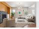 Staged living room with a modern couch and stylish decor at 5021 S Rome St, Aurora, CO 80015