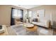 Bright living room with stylish furniture, large windows, and a modern decorative rug at 5021 S Rome St, Aurora, CO 80015