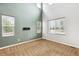 Bright living room featuring large windows and neutral carpet flooring at 5021 S Rome St, Aurora, CO 80015