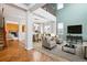 Bright open-concept living space with tall ceilings, carpet, a fireplace, and dining area at 5021 S Rome St, Aurora, CO 80015