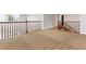 Spacious loft area with access to stairs and a hallway at 5021 S Rome St, Aurora, CO 80015