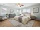 Stylish main bedroom with neutral paint, a ceiling fan, and bright, natural light at 5021 S Rome St, Aurora, CO 80015