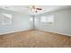Main bedroom featuring neutral paint, a ceiling fan, and bright, natural light at 5021 S Rome St, Aurora, CO 80015