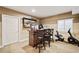 Basement bar area with a stylish bar, comfortable seating, and entertainment features at 5128 Longs Peak St, Brighton, CO 80601