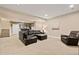 Finished basement with a large sectional sofa, and a bar provides a versatile living and entertainment area at 5128 Longs Peak St, Brighton, CO 80601