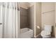 Well-maintained bathroom featuring a shower and tub combo with modern fixtures and a toilet at 5128 Longs Peak St, Brighton, CO 80601