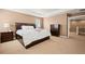 Bedroom with carpet flooring, closet and ensuite access, and dresser at 5128 Longs Peak St, Brighton, CO 80601