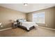 Cozy bedroom featuring neutral walls, carpet flooring, and a bright window at 5128 Longs Peak St, Brighton, CO 80601