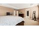Bedroom features tray ceiling, carpet flooring and view into closet at 5128 Longs Peak St, Brighton, CO 80601
