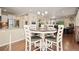 Open concept dining area featuring hardwood floors and seating for four at 5128 Longs Peak St, Brighton, CO 80601