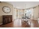 Bright dining area with hardwood floors, large windows, and backyard access at 5128 Longs Peak St, Brighton, CO 80601