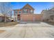 Beautiful two-story home featuring a brick facade and attached two car garage at 5128 Longs Peak St, Brighton, CO 80601