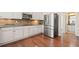 Modern kitchen featuring stainless steel appliances, ample counter space, and dark backsplash at 5128 Longs Peak St, Brighton, CO 80601