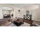 Spacious living room with open layout to dining area and entry at 5128 Longs Peak St, Brighton, CO 80601