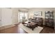 Inviting living room with hardwood floors, neutral paint, and bay window at 5128 Longs Peak St, Brighton, CO 80601