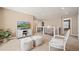 Bright sitting area with comfortable seating, a TV, and neutral decor provides a cozy space for relaxation at 5128 Longs Peak St, Brighton, CO 80601