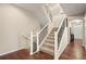 Lovely staircase with carpeted steps and decorative wrought iron railing at 5128 Longs Peak St, Brighton, CO 80601