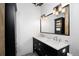Modern bathroom featuring double sinks, contemporary fixtures, and decorative tile flooring at 1301 Wazee St # 3C, Denver, CO 80204