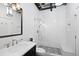 Modern bathroom with black and white tile, glass shower, and sleek vanity at 1301 Wazee St # 3C, Denver, CO 80204