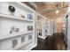 Hallway with hardwood floors and built-in shelving for storage and decoration at 1301 Wazee St # 3C, Denver, CO 80204